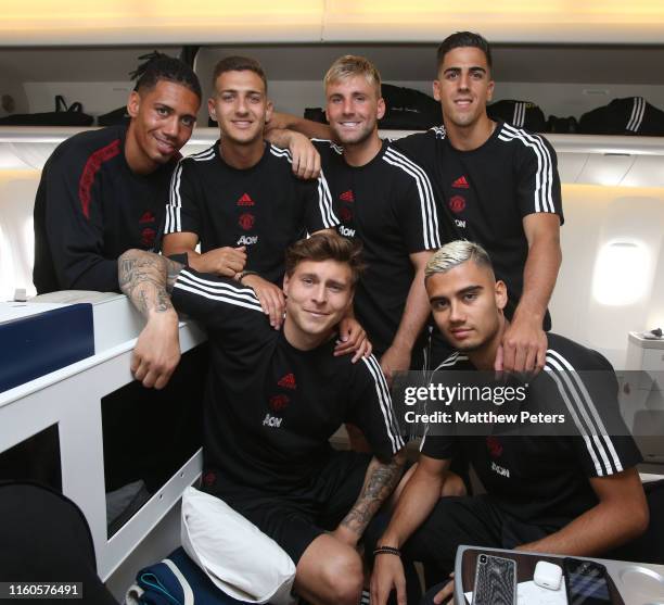 Chris Smalling, Diogo Dalot, Luke Shaw, Joel Pereira, Victor Lindelof and Andreas Pereira of Manchester United pose on the plane ahead of their...