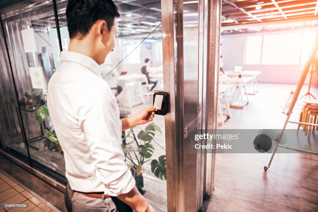 Male staff scan the Security card to enter the operating room
