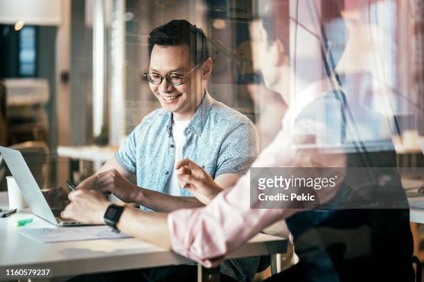 business professional in spite of hearing disability - asian guy background stock pictures, royalty-free photos & images
