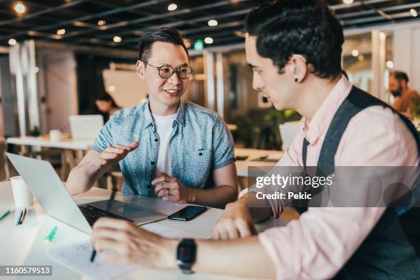 business professional in spite of hearing disability - asian man white background stock pictures, royalty-free photos & images