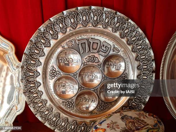 close-up of ornate passover seder plate engraved with the names of the symbolic foods placed on it on the passover evening - passover seder plate fotografías e imágenes de stock