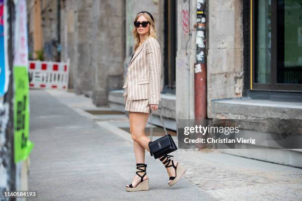 Inga Brauer is seen wearing linen blazer and paperpag shorts NA-KD, silk top Asos, raffia sandals Glamorous, bag YSL, hair loop on July 06, 2019 in...