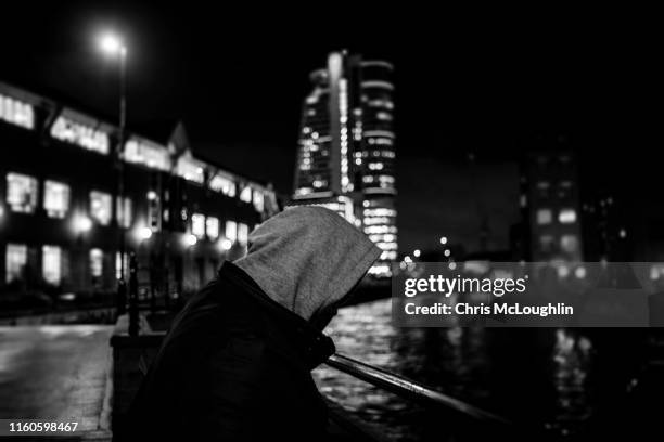 single peron standing by the river aire in leeds - drug addict stock-fotos und bilder