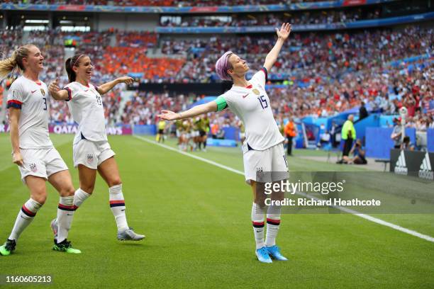 Megan Rapinoe of the USA celebrates after scoring her team's first goal with team mates Samantha Mewis and Alex Morgan during the 2019 FIFA Women's...