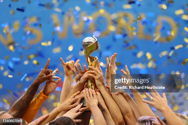 Carli Lloyd of the USA lifts the FIFA Women's World Cup Trophy following her team's victory in the 2019 FIFA Women's World Cup France Final match...