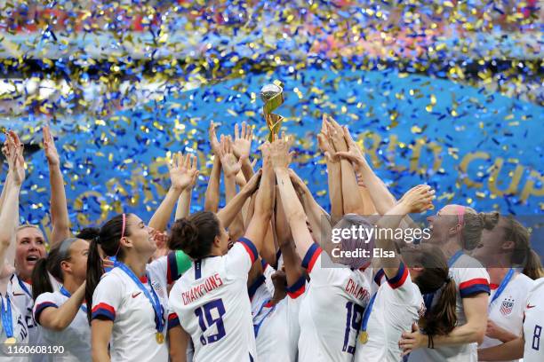 Players of the USA lift the Women's World Cup Trophy following the 2019 FIFA Women's World Cup France Final match between The United States of...