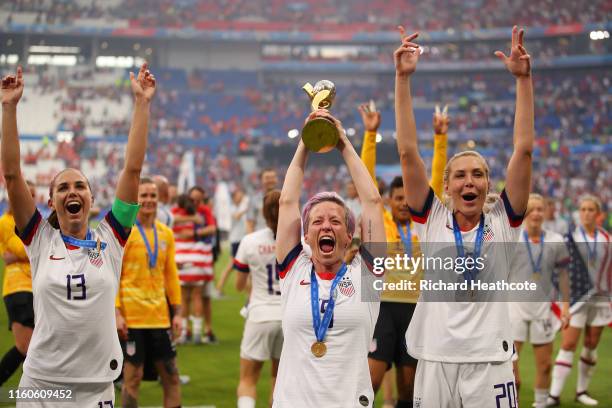 Megan Rapinoe of the USA celebrates with the FIFA Women's World Cup Trophy following her team's victory in the 2019 FIFA Women's World Cup France...