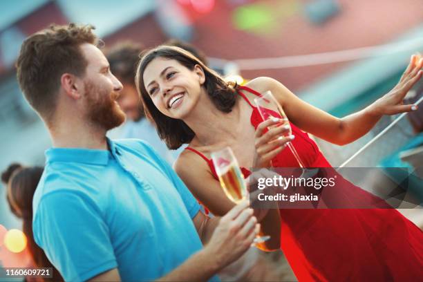 rooftop party on a summer evening. - champagne rooftop stock pictures, royalty-free photos & images