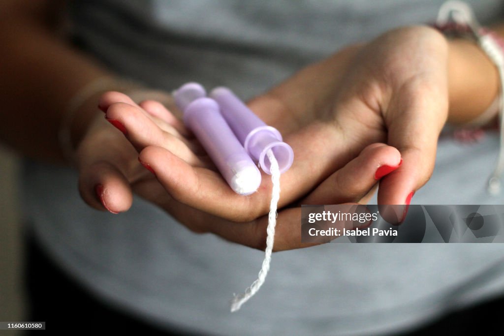 Close-Up Of Woman Hand Holding Tampons