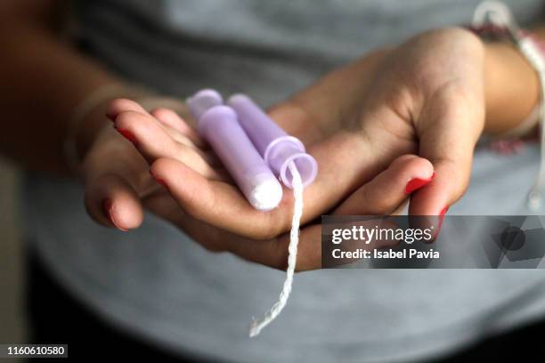 close-up of woman hand holding tampons - sanitary napkins stock pictures, royalty-free photos & images