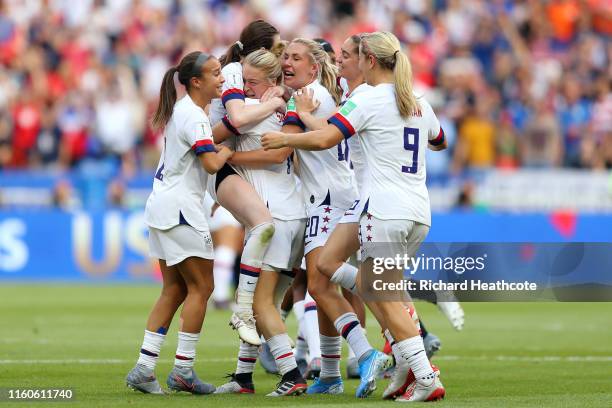 Rose Lavelle of the USA celebrates with Emily Sonnett and teammates following the 2019 FIFA Women's World Cup France Final match between The United...