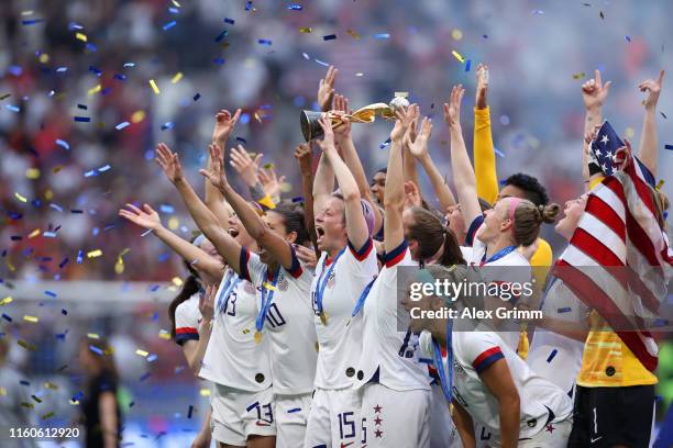 Megan Rapinoe of the USA lifts the FIFA Women's World Cup Trophy following her team's victory in the 2019 FIFA Women's World Cup France Final match...