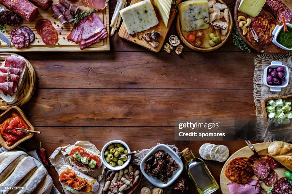 Tapas von gehärtetem Schinken und Käse köstliche Vorspeise auf rustikalen Holztisch mit Kopierraum