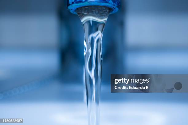 water coming out of a tap - faucet fotografías e imágenes de stock