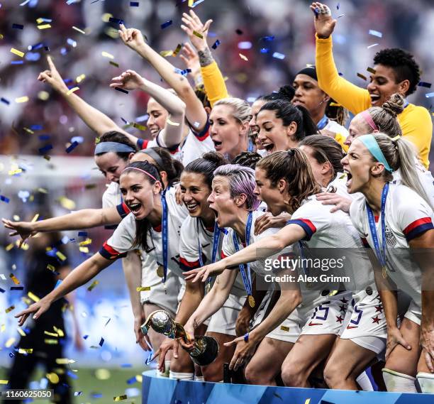 Megan Rapinoe of the USA lifts the FIFA Women's World Cup Trophy following her team's victory in the 2019 FIFA Women's World Cup France Final match...