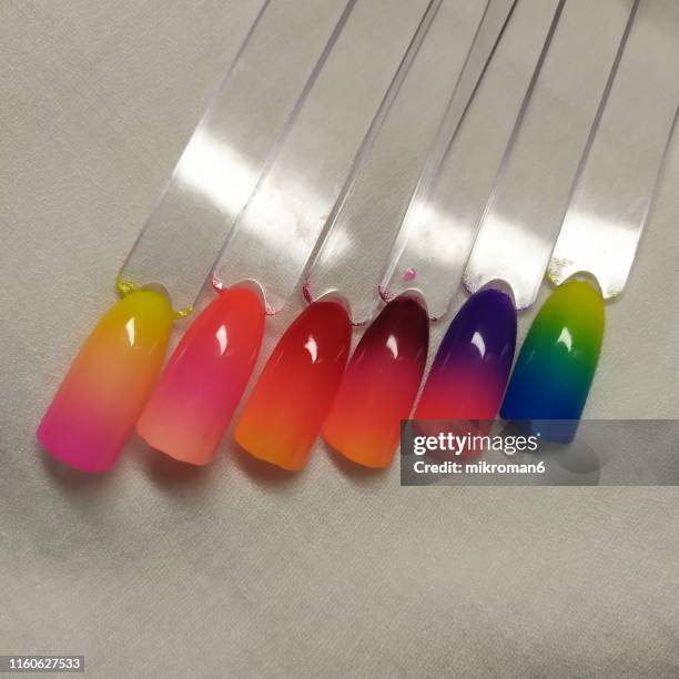 close-up of colorful artificial nails in ombre colours - ombré imagens e fotografias de stock