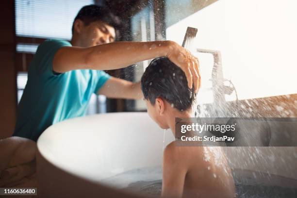 father washing his sons hair - bathing stock pictures, royalty-free photos & images