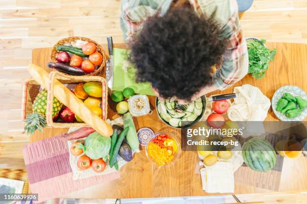 friends preparing vegetarian food for home party - jamaican ethnicity imagens e fotografias de stock