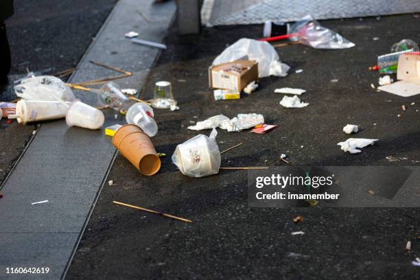 litter, plastic waste and rubbish laying on the street, background with copy space - littering stock pictures, royalty-free photos & images