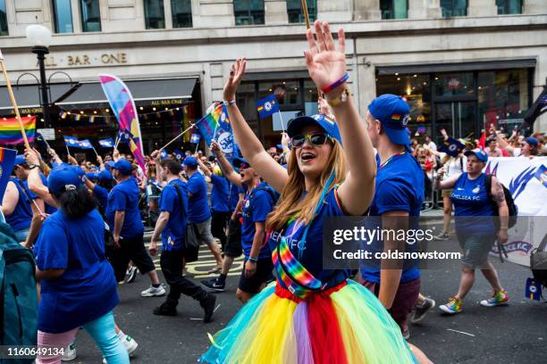 chelsea fc celebrating at gay pride parade on streets of central london, uk - chelsea fc flag stock pictures, royalty-free photos & images
