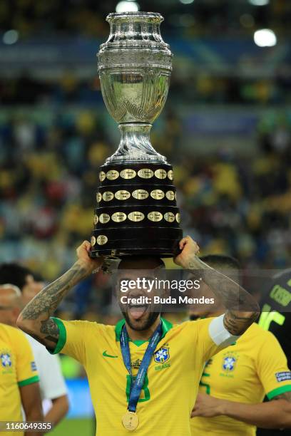 Dani Alves of Brazil celebrates with teh trophy after winning the Copa America Brazil 2019 Final match between Brazil and Peru at Maracana Stadium on...