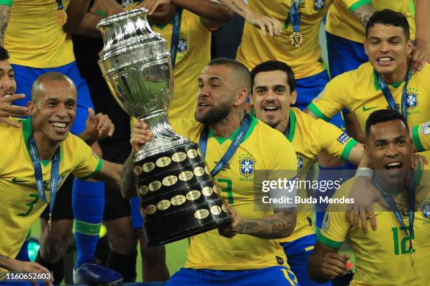 Dani Alves of Brazil celebrates with the trophy and his teammates after winning the Copa America Brazil 2019 Final match between Brazil and Peru at...