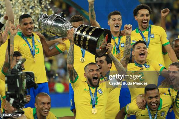 Dani Alves of Brazil celebrates with the trophy and his teammates after winning the Copa America Brazil 2019 Final match between Brazil and Peru at...