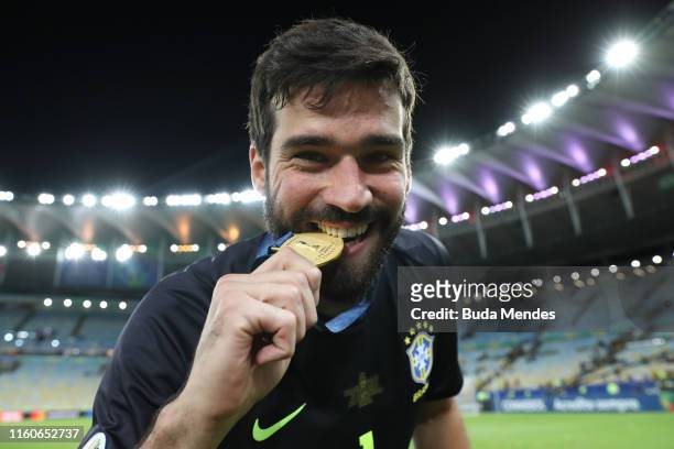 Alisson Becker of Brazil bites his champion medal after winning the Copa America Brazil 2019 Final match between Brazil and Peru at Maracana Stadium...