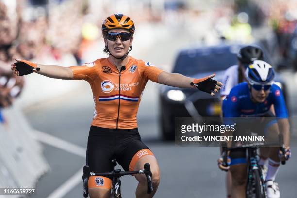 Dutch cyclist Amy Pieters celebrates as she crosses the finish line in front of second-placed Italy's Elena Cecchini , and wins the women's Elite...