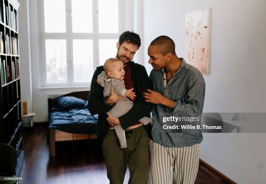 Gay Fathers leaving Bedroom with Son