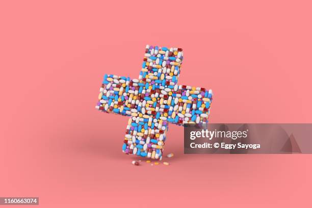 cross shaped pills and capsules 2 - medical symbol stock pictures, royalty-free photos & images