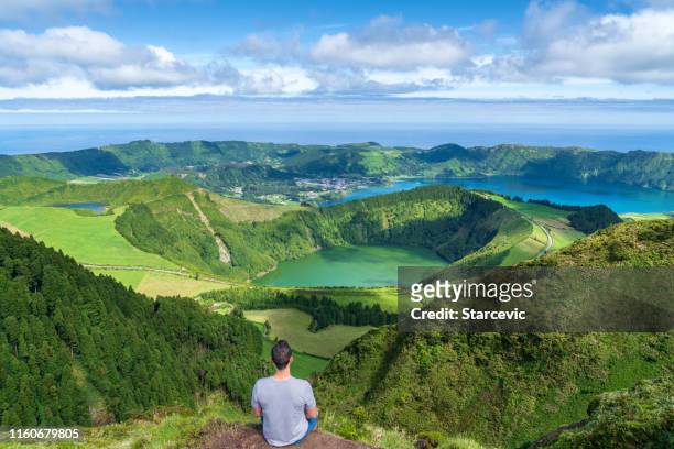 young man at sete cidades lake in the azores - azores stock pictures, royalty-free photos & images