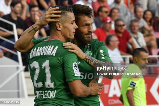 Saint-Etienne's French midfielder Romain Hamouma is congratuled by teamate Saint-Etienne's French defender Mathieu Debuchy after scoring a goal...