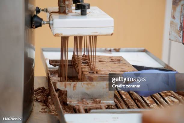 filling mould with melted chocolate - chocolate factory stock pictures, royalty-free photos & images