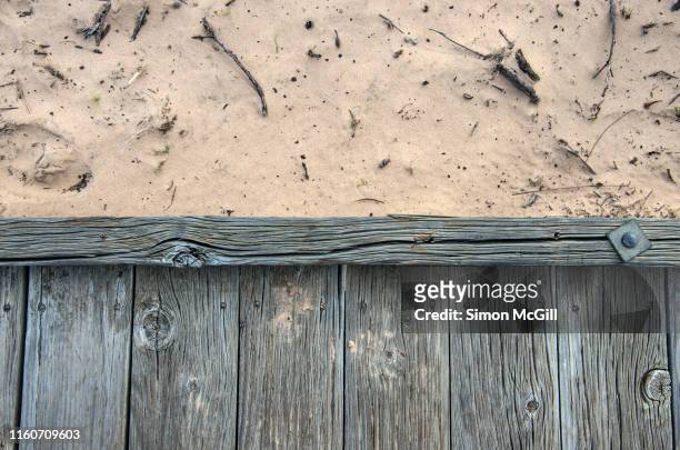 old wooden boardwalk over sand dune - old fashioned australian beach foto e immagini stock