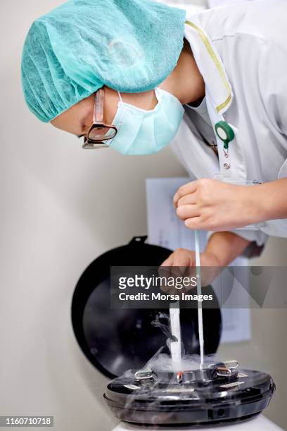 medical professional studying cryobiology in lab - egg freezing stock pictures, royalty-free photos & images