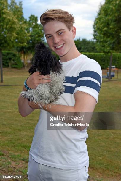 Vincent Gross and his dog Britney during the summer open air of Bundesverband Kinderhospiz at Helvetia Parc on July 6, 2019 in Gross-Gerau, Germany.