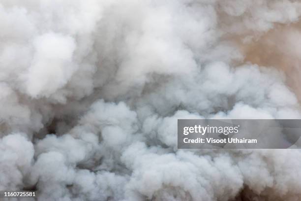 billowing black smoke from ignition midden. - smoke black background stock-fotos und bilder