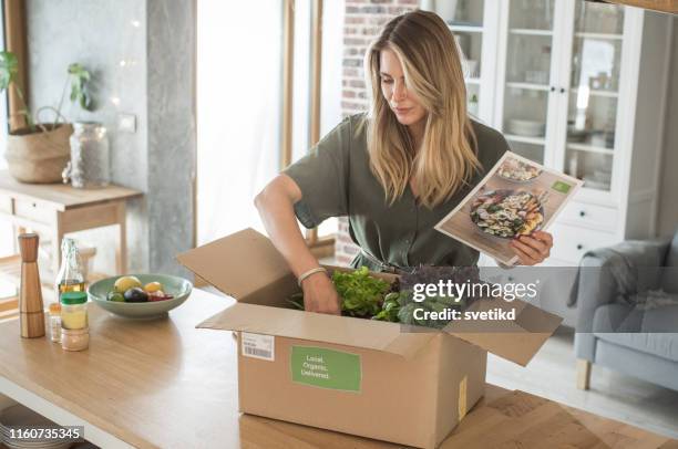 woman got package from meal delivery service. - food package stock pictures, royalty-free photos & images