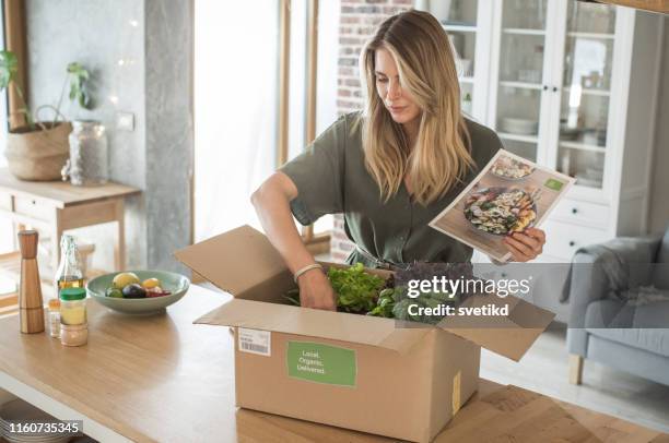 woman got package from meal delivery service. - food box stock pictures, royalty-free photos & images