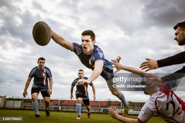 scoring touchdown in a jump! - rugby league stock pictures, royalty-free photos & images