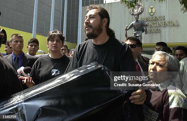 Mexican protesters from a bank debtors organization hold a mock coffin outside the Mexico City hotel where repersentatives from 18 countries are...