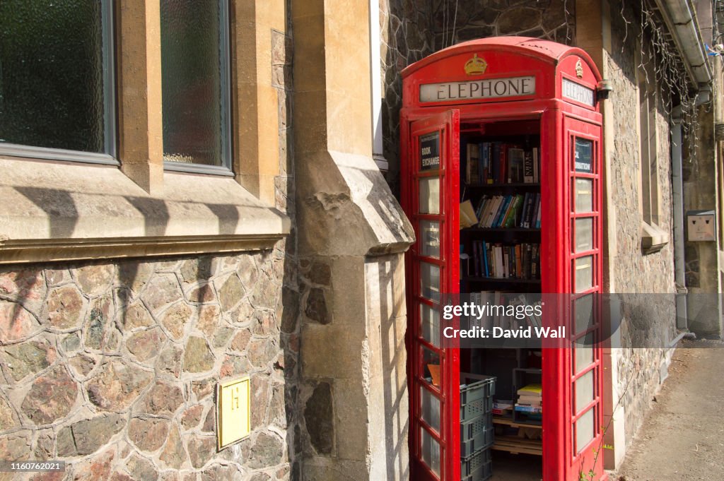 An old red telephone box, used as a community library, Malvern, Worcestershire, UK.