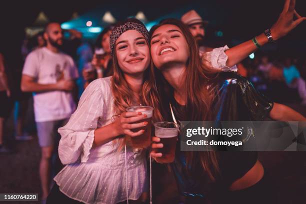 best friends enjoying summer music festival - girls party alcohol stock pictures, royalty-free photos & images