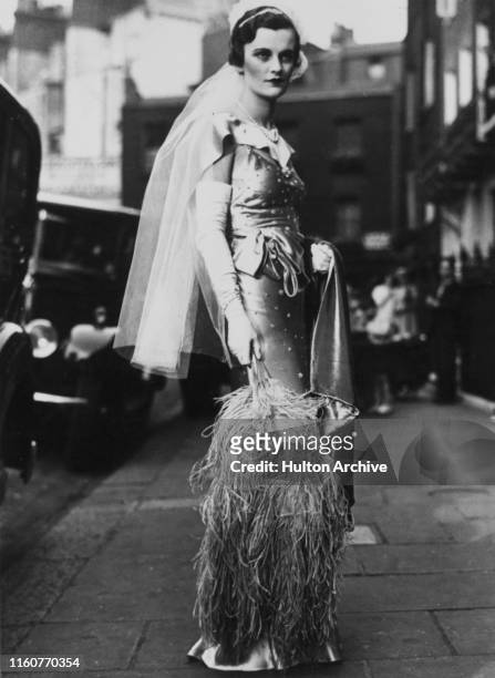 English socialite Margaret Whigham on her way to be presented at the third Court of the season, at Buckingham Palace, London, 12th June 1934.