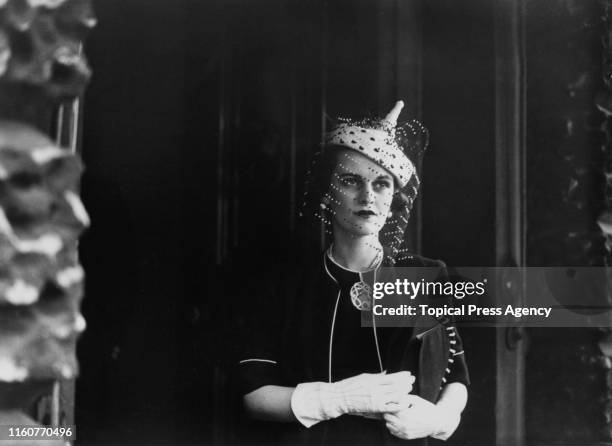 English socialite Margaret Sweeny wearing a veiled hat and matching gloves, London, 5th May 1938. She is leaving Derby House on Stratford Place after...