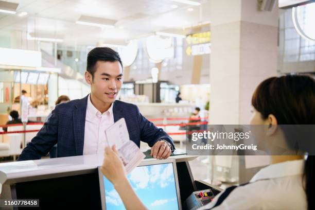 businessman having passport checked - showing card stock pictures, royalty-free photos & images