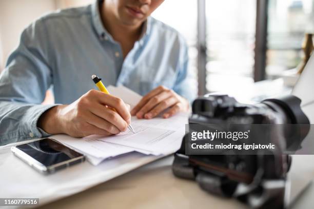 unrecognizable paparazzo signing contract - journalist stock pictures, royalty-free photos & images