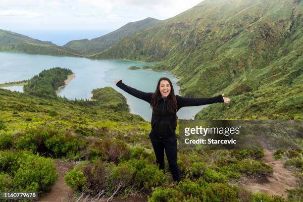 young woman hiking at lagoa do fogo, the azores - azores people stock pictures, royalty-free photos & images