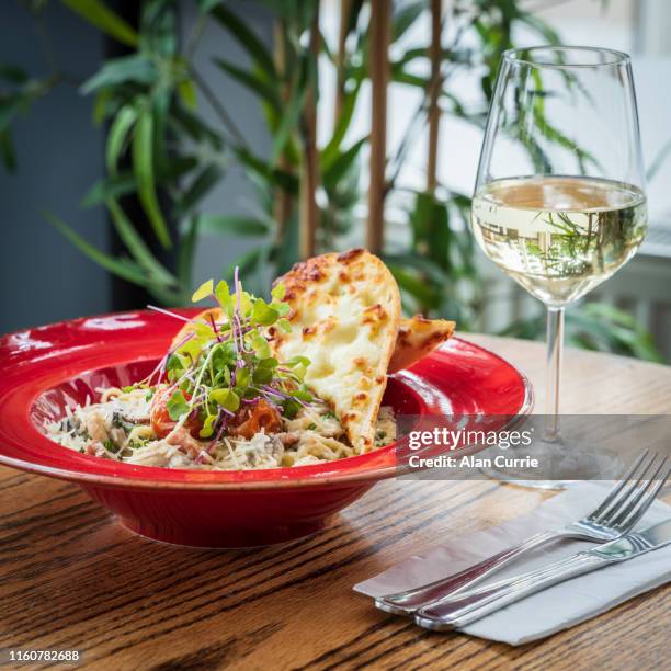 pasta carbonara linguini in a creamy sauce, with cheese garlic bread - garlic bread stock pictures, royalty-free photos & images